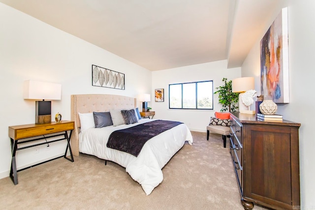 bedroom with light carpet and baseboards