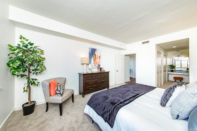 carpeted bedroom featuring ensuite bathroom