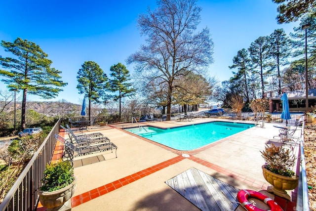 community pool featuring a patio and fence