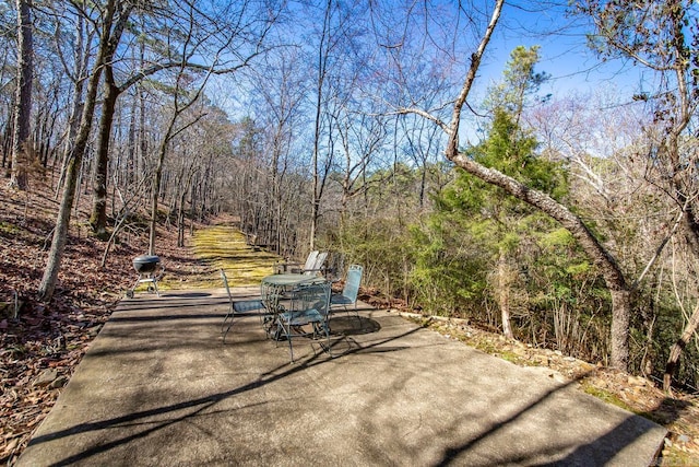 view of patio featuring a forest view