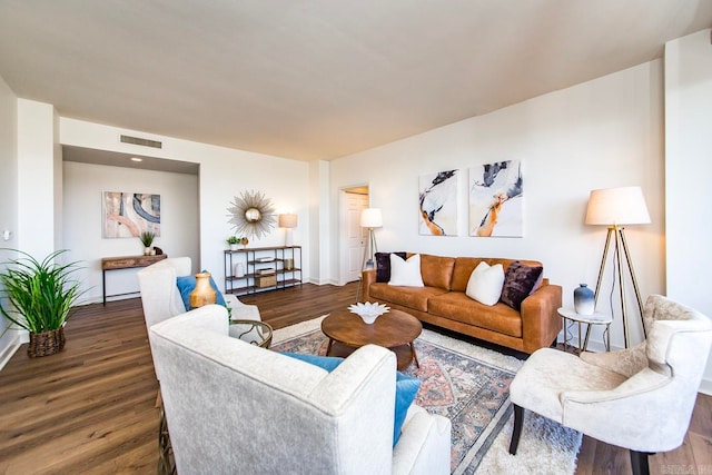 living room with visible vents and dark wood finished floors