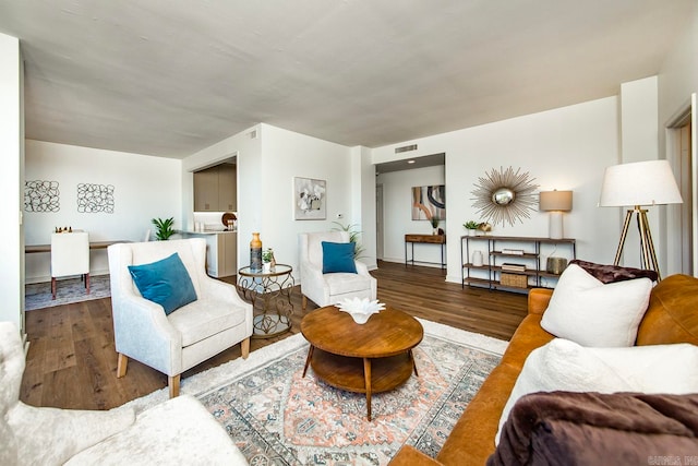 living room featuring visible vents and wood finished floors