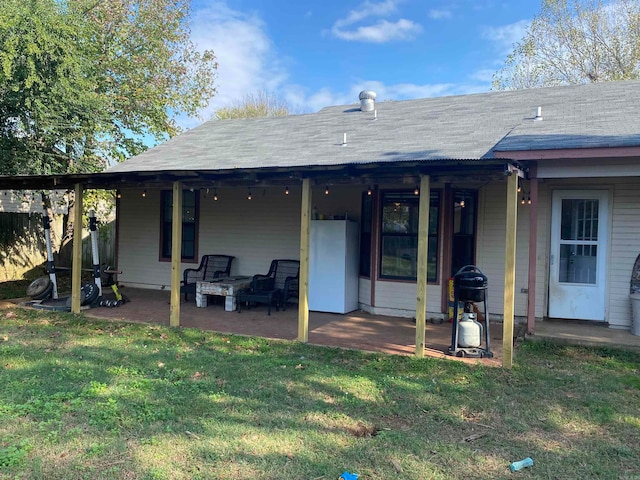 rear view of house with a patio area and a lawn