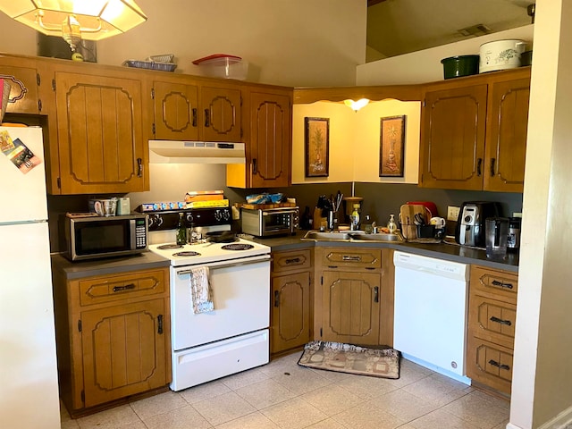 kitchen featuring sink, white appliances, and light tile patterned floors