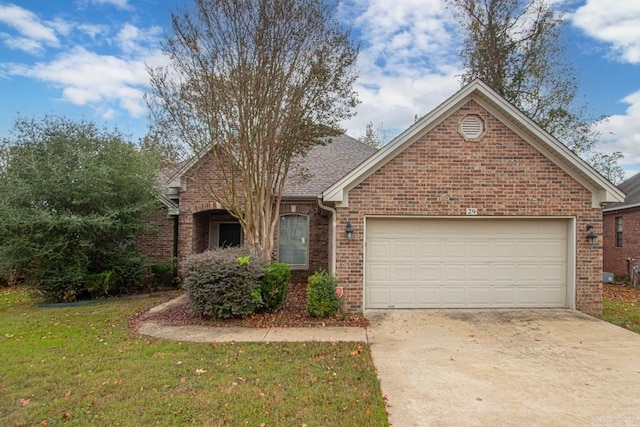 view of front of home featuring a front lawn and a garage