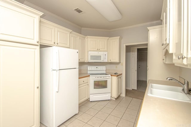 kitchen with light tile patterned flooring, white appliances, sink, and ornamental molding