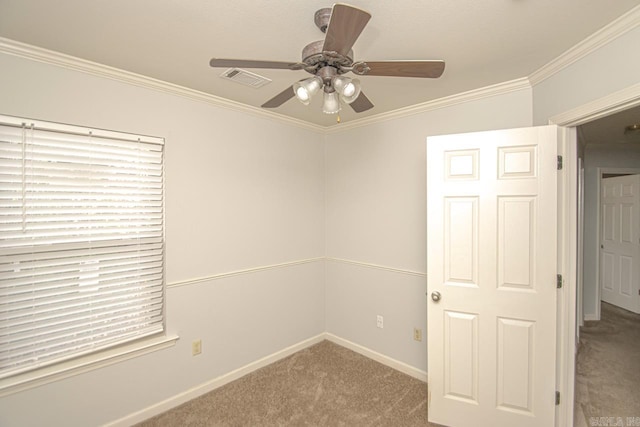 carpeted empty room featuring ceiling fan and ornamental molding