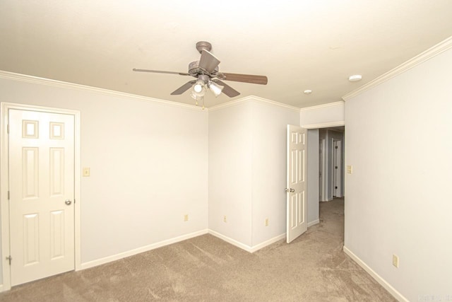 carpeted empty room featuring ornamental molding and ceiling fan