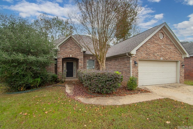 view of front of house with a garage and a front yard