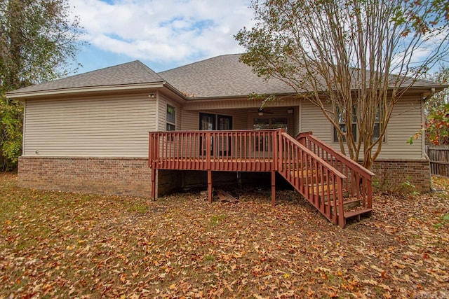 rear view of property featuring a wooden deck