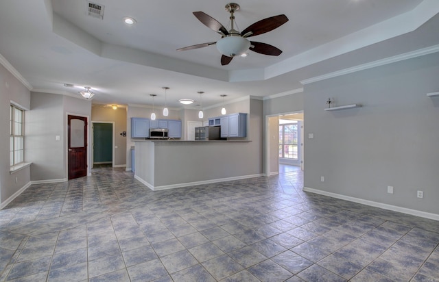 unfurnished living room with ceiling fan, a tray ceiling, and ornamental molding