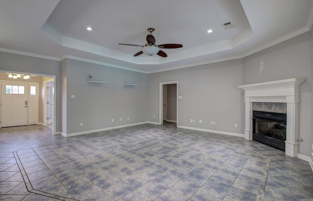 unfurnished living room with a fireplace, a raised ceiling, ceiling fan, and crown molding