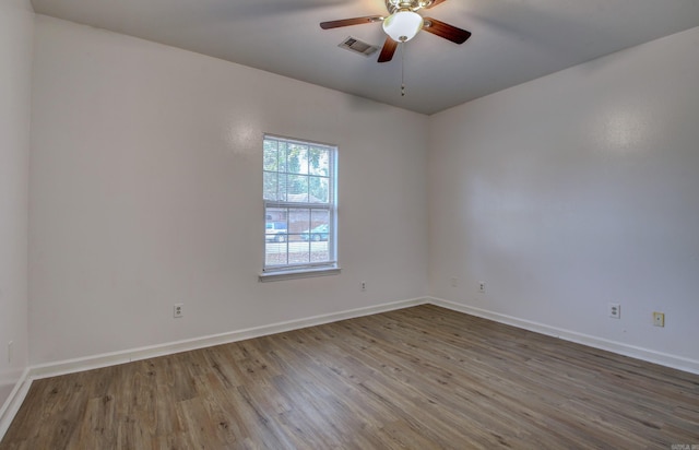 unfurnished room with hardwood / wood-style flooring and ceiling fan