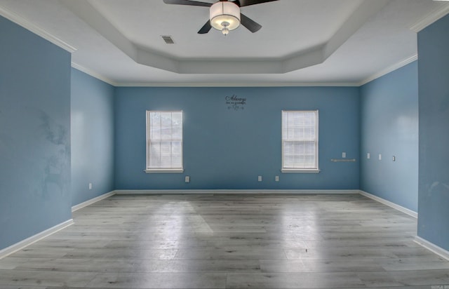 empty room with light wood-type flooring, plenty of natural light, ceiling fan, and crown molding