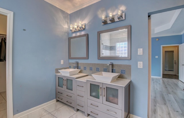 bathroom with decorative backsplash, vanity, crown molding, and wood-type flooring