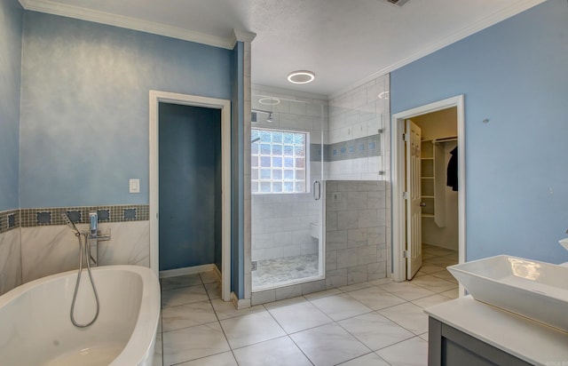 bathroom with vanity, plus walk in shower, crown molding, tile patterned floors, and tile walls