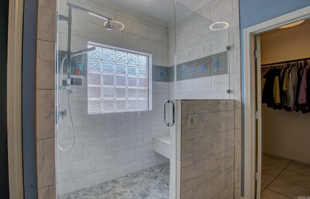 bathroom featuring an enclosed shower and tile patterned floors