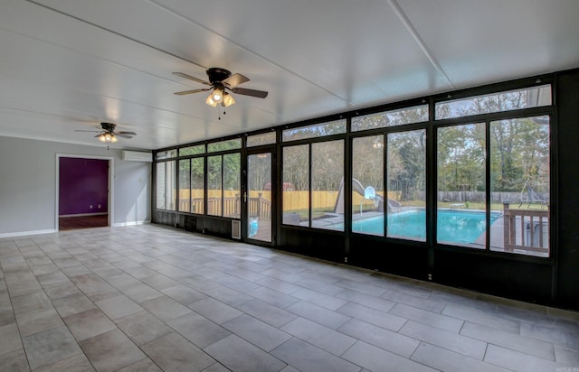 unfurnished sunroom featuring ceiling fan and a healthy amount of sunlight