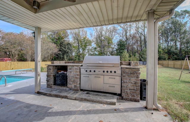 view of patio / terrace featuring an outdoor kitchen, area for grilling, and a fenced in pool