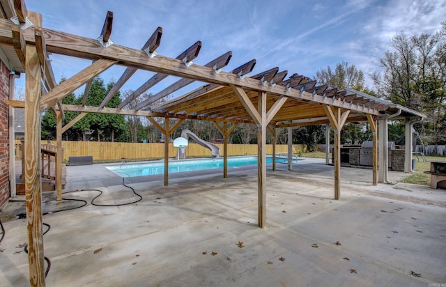 exterior space featuring a water slide, a pergola, and a patio area