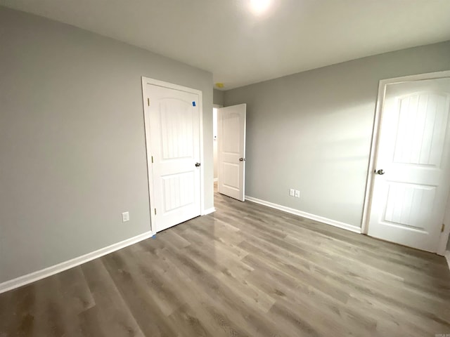 unfurnished bedroom featuring hardwood / wood-style floors