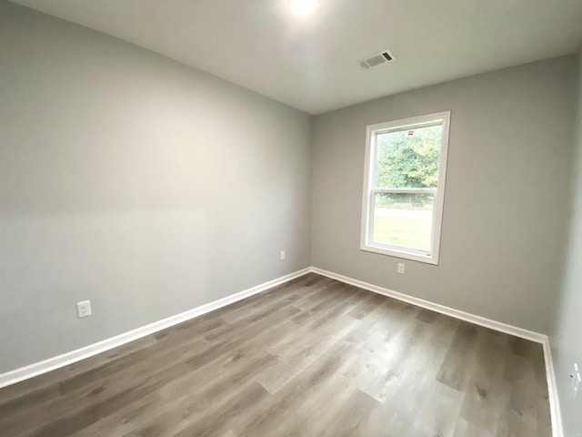 spare room with hardwood / wood-style floors