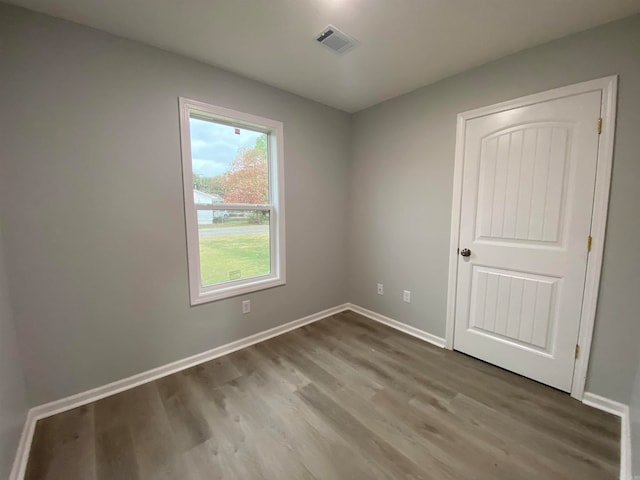 unfurnished room with light wood-type flooring