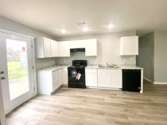 kitchen with white cabinetry, sink, black appliances, and a healthy amount of sunlight