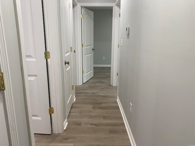 hallway with light hardwood / wood-style flooring