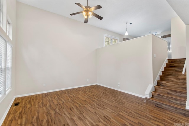 26 Summerwood Cv, Benton, AR 72015 - unfurnished living room featuring wood finished floors, a ceiling fan, baseboards, and stairway