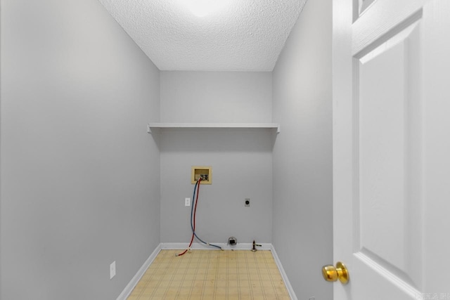 clothes washing area featuring a textured ceiling, hookup for an electric dryer, and hookup for a washing machine