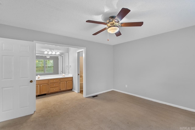 26 Summerwood Cv, Benton, AR 72015 - unfurnished bedroom featuring light carpet, baseboards, connected bathroom, and a ceiling fan