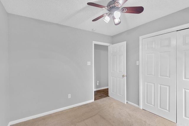 26 Summerwood Cv, Benton, AR 72015 - unfurnished bedroom featuring carpet floors, a closet, a textured ceiling, baseboards, and ceiling fan