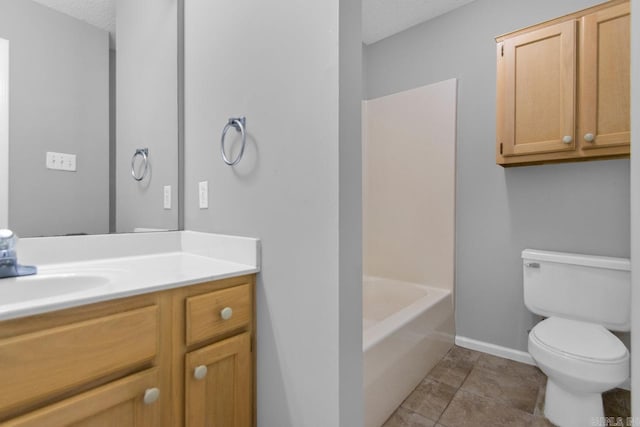 bathroom featuring vanity, tile patterned flooring, a textured ceiling, and toilet