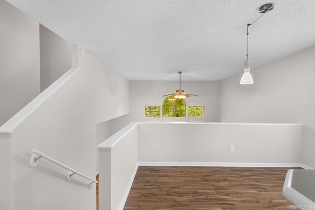 26 Summerwood Cv, Benton, AR 72015 - stairway featuring wood finished floors, a textured ceiling, ceiling fan, and baseboards