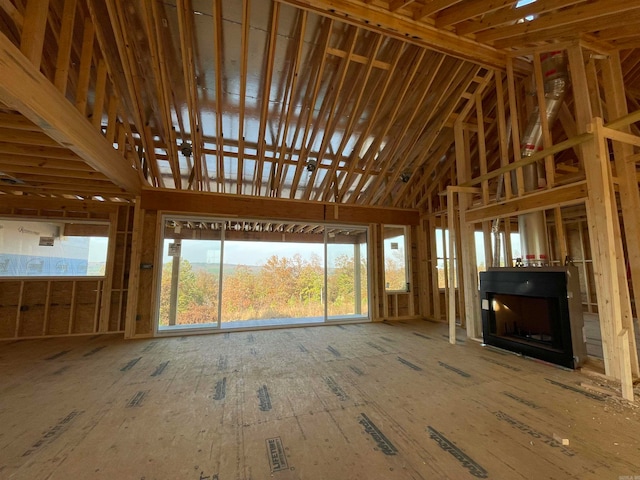 miscellaneous room featuring a fireplace and a towering ceiling