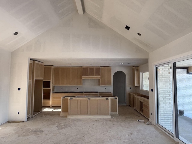 kitchen with beam ceiling, light brown cabinets, and high vaulted ceiling