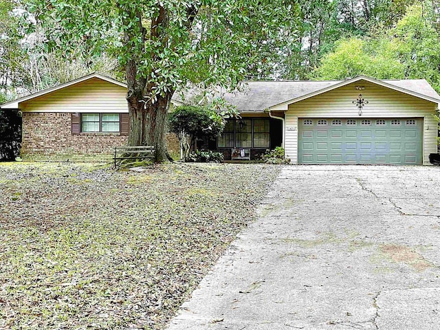 single story home featuring an attached garage and driveway