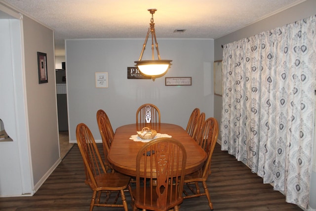 dining area featuring a textured ceiling and dark hardwood / wood-style floors