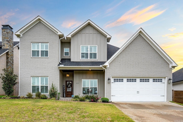 view of front of home featuring a garage and a yard