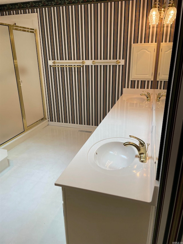 bathroom featuring walk in shower and vanity