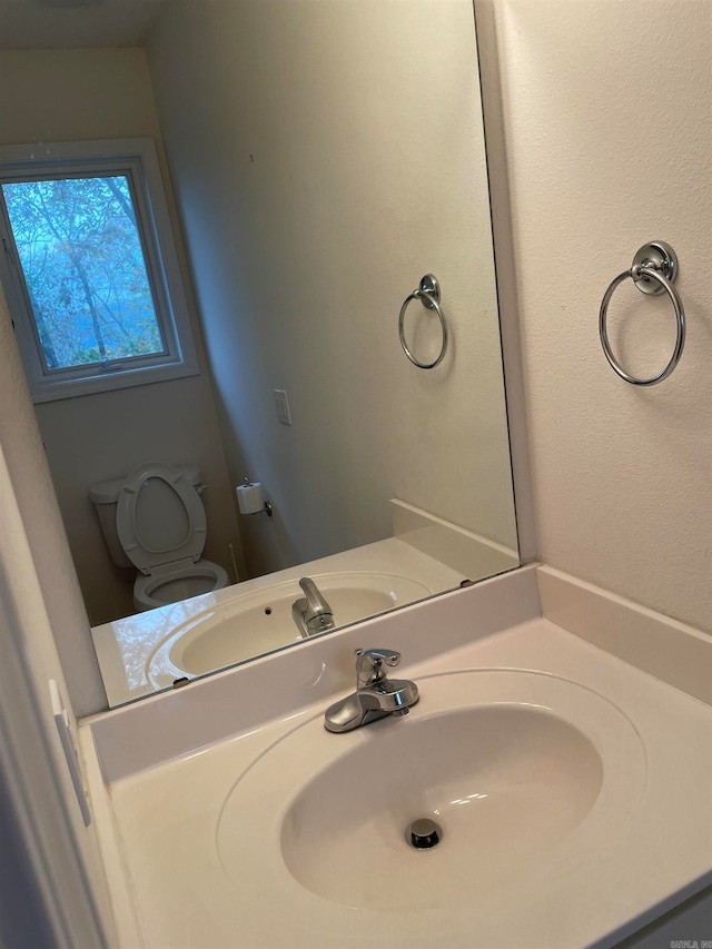 bathroom featuring toilet and vanity