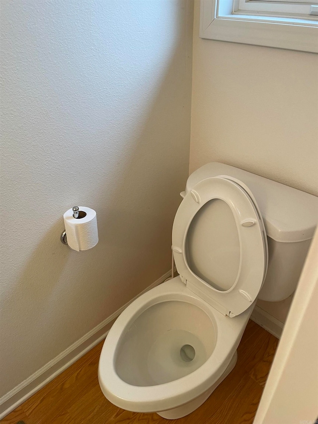 bathroom with hardwood / wood-style floors and toilet