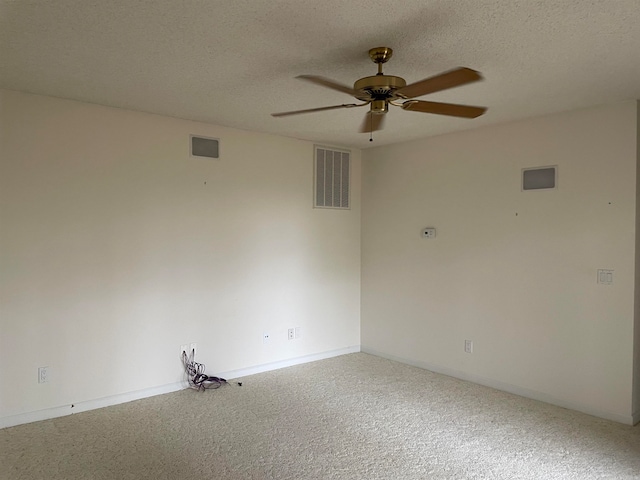 carpeted spare room with a textured ceiling and ceiling fan