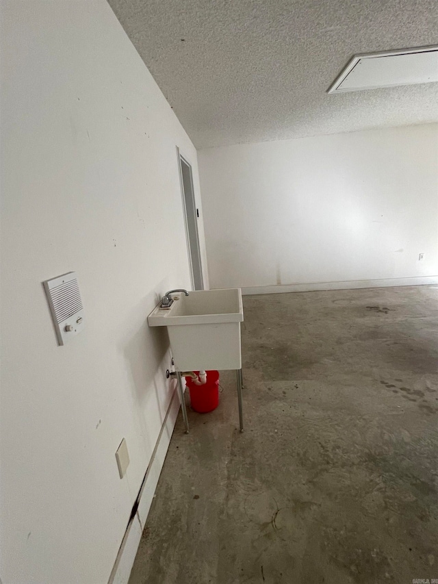 interior space featuring a textured ceiling and sink