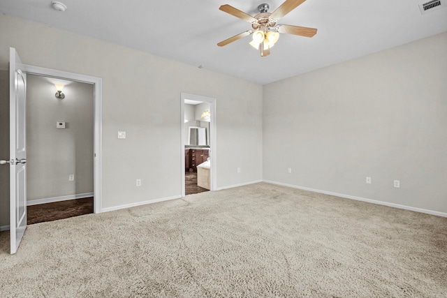 unfurnished bedroom with carpet, ceiling fan, and connected bathroom