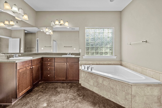 bathroom featuring a relaxing tiled tub and vanity