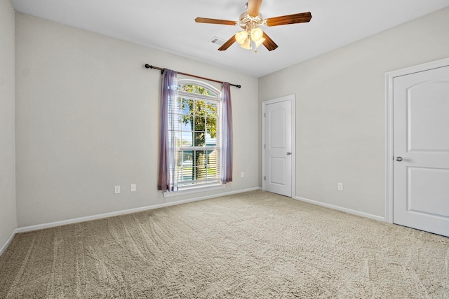 empty room featuring ceiling fan and carpet floors