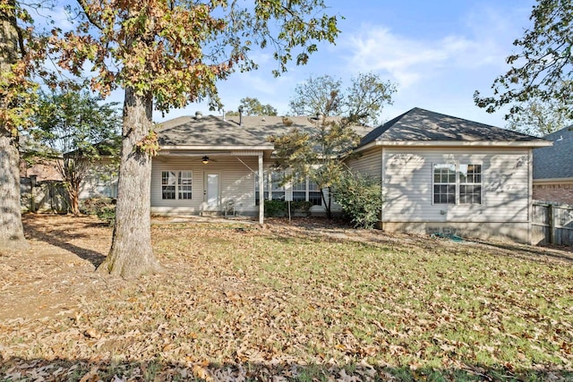 rear view of property with a yard