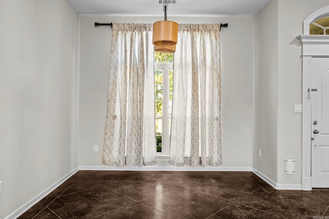 foyer entrance with dark tile patterned flooring